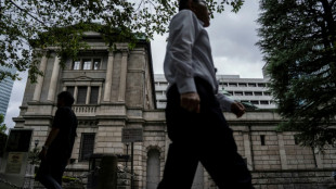 Global stocks mixed as yen falls despite Bank of Japan rate hike